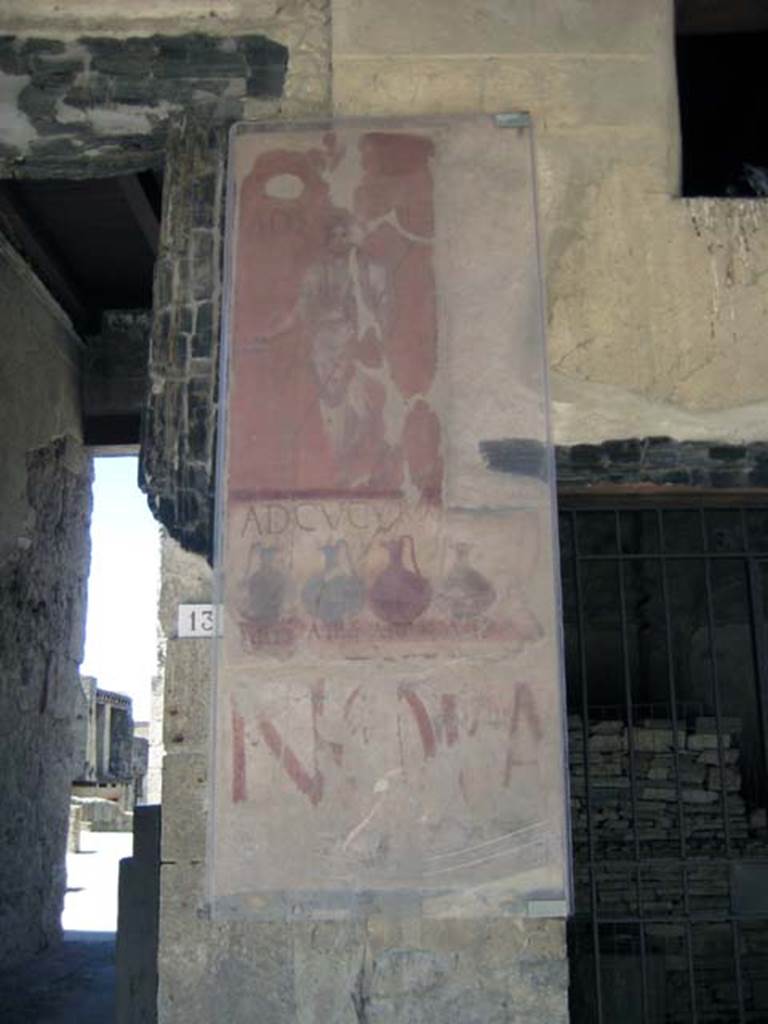 VI.13 Herculaneum on left, VI.14 on right. June 2011.
Painted sign on pilaster between house entrance and shop. Looking south.
Photo courtesy of Sera Baker.